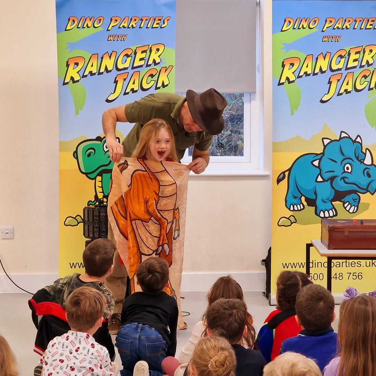 Happy children smiling whilst taking part in a Dino Party with Ranger Jack